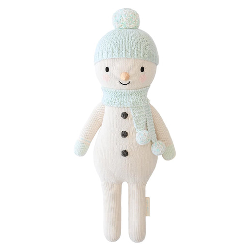 Full front view of Spruce the Snowman, featuring a mint pom-pom hat, matching scarf, black button details, and cream knitted body.