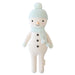 Full front view of Spruce the Snowman, featuring a mint pom-pom hat, matching scarf, black button details, and cream knitted body.