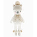 Front view of Stella the Polar Bear doll wearing a knit hat with pom-pom, fuzzy vest, and pom-pom ankle cuffs, smiling with blush cheeks.