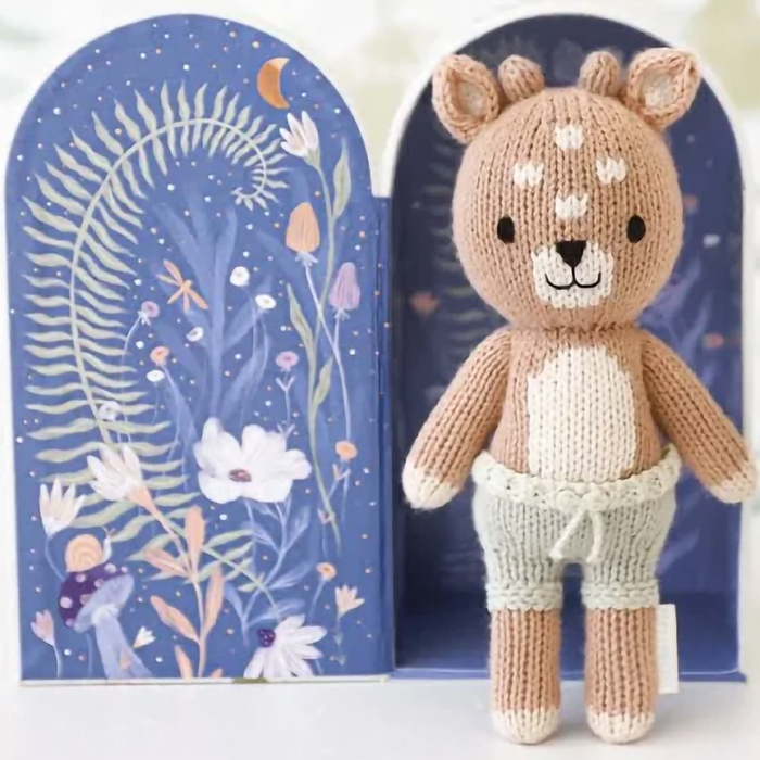 Cuddle + Kind Tiny Elliott the Fawn plush displayed inside open storybook keepsake box with woodland design