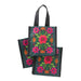 A hand holds a small bag featuring a colorful floral design against a neutral background.