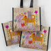 A hand is holding a cheerful bag that features colorful illustrations of cats and dogs.