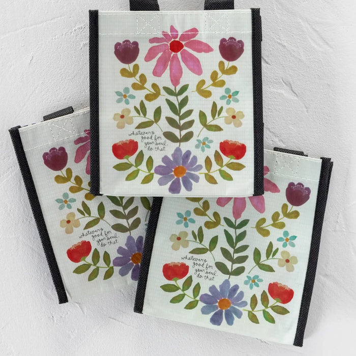 Three bags adorned with vibrant flowers and hearts, creating a playful and festive look.