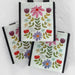 Three bags adorned with vibrant flowers and hearts, creating a playful and festive look.