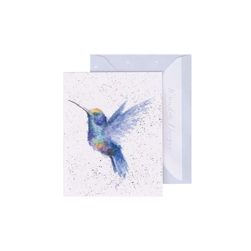 A greeting card featuring a colorful hummingbird in flight against a soft background.
