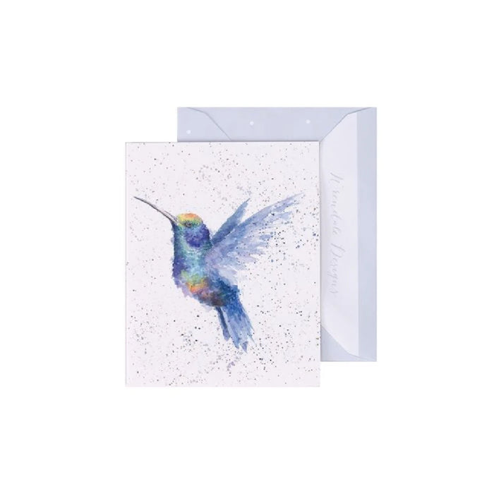 A greeting card featuring a colorful hummingbird in flight against a soft background.