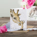 A card displaying a mother giraffe and her calf, showcasing their bond in a vibrant landscape.