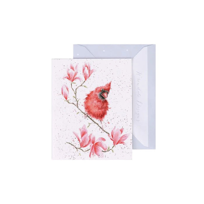 A red cardinal perched on a branch, featured prominently on a decorative card.