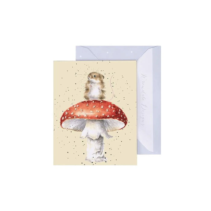 A small mouse sitting atop a colorful mushroom, illustrated on a charming greeting card.