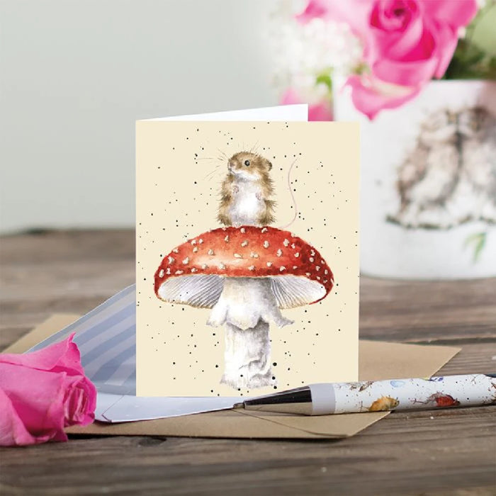 A delightful card showcasing a mouse resting on a mushroom, adding a playful touch to the design.