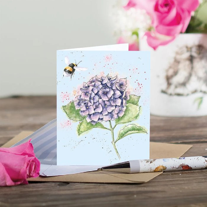 An artistic card displaying a bee on a hydrangea flower, emphasizing the harmony of wildlife and flora.