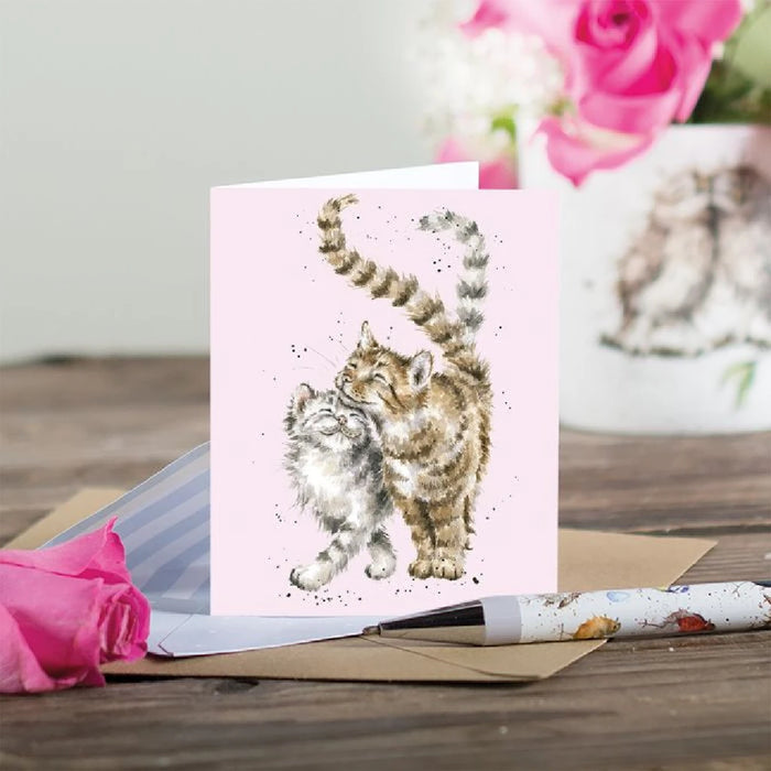 A cheerful greeting card displaying two adorable cats with bright, whimsical designs.