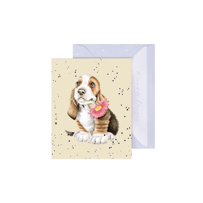  A whimsical birthday card depicting a basset hound celebrating with a party hat, balloons, and a joyful birthday theme.