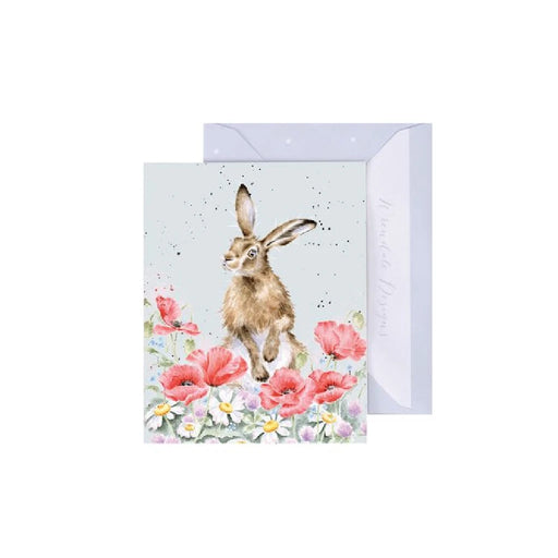 A card featuring a rabbit perched atop a colorful arrangement of flowers, creating a cheerful springtime scene.