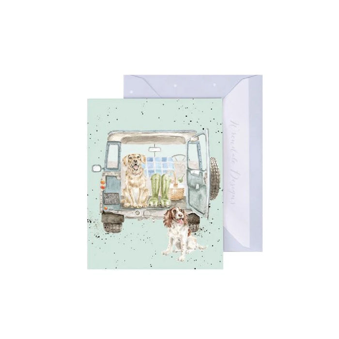 A cheerful greeting card depicting a dog and a cat lounging in the back of a van, symbolizing companionship.