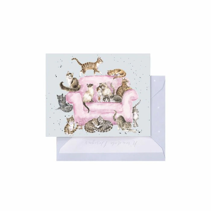 A greeting card showcasing a pink sofa with several cats lounging comfortably on it.