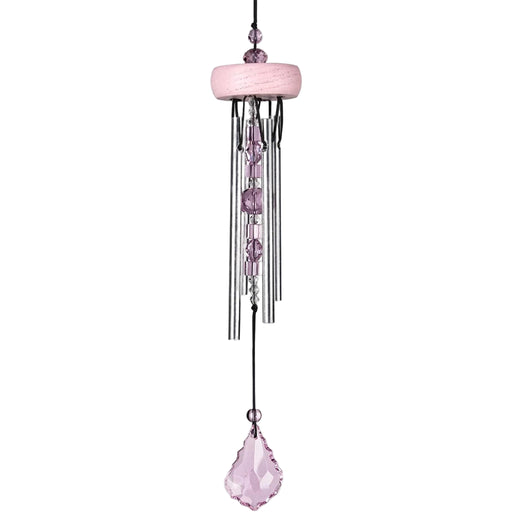 Pink wind chime with crystals on a white background