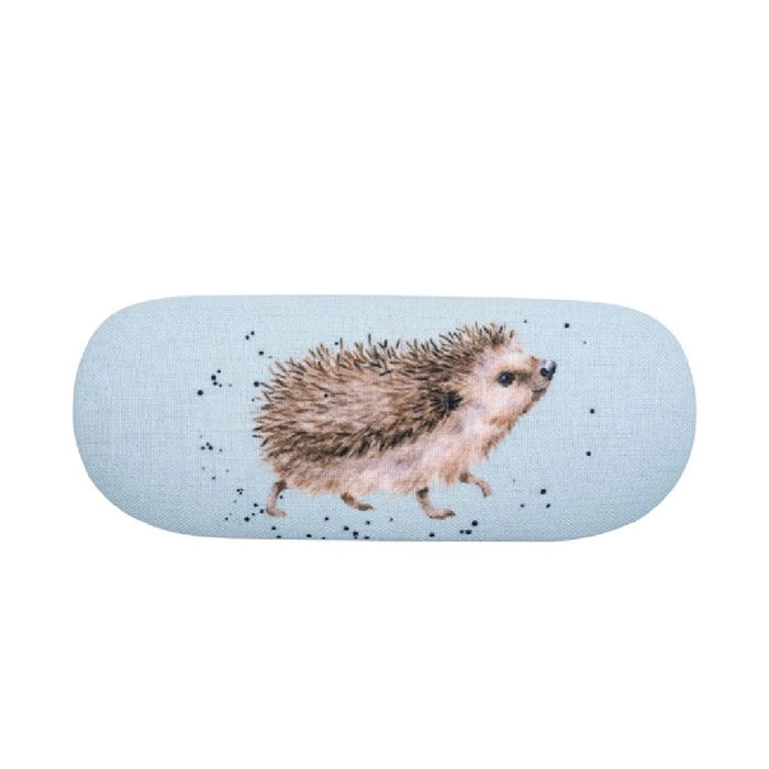 A hedgehog surrounded by blooming bluebells against a bright blue backdrop, highlighting a peaceful garden setting.