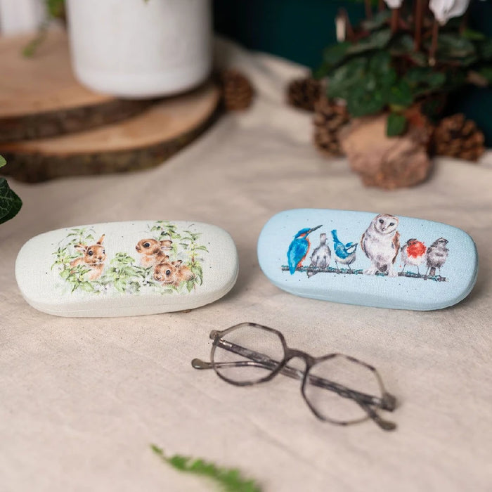 A pair of glasses with an intricate bird design painted on them.