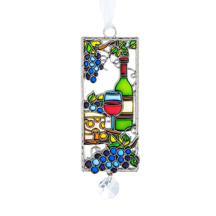 Decorative stained glass ornament with wine bottle, grapes, and glass on a white background