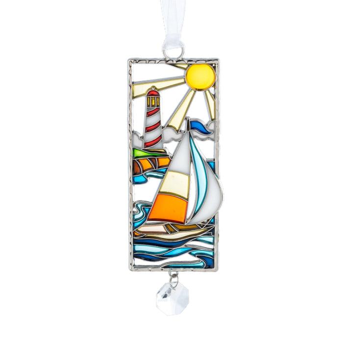 Decorative glass ornament with sailboat and lighthouse design on a white background