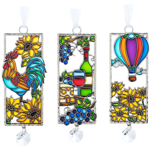 Three colorful stained glass window hangings featuring a rooster, wine bottle, and hot air balloon.
