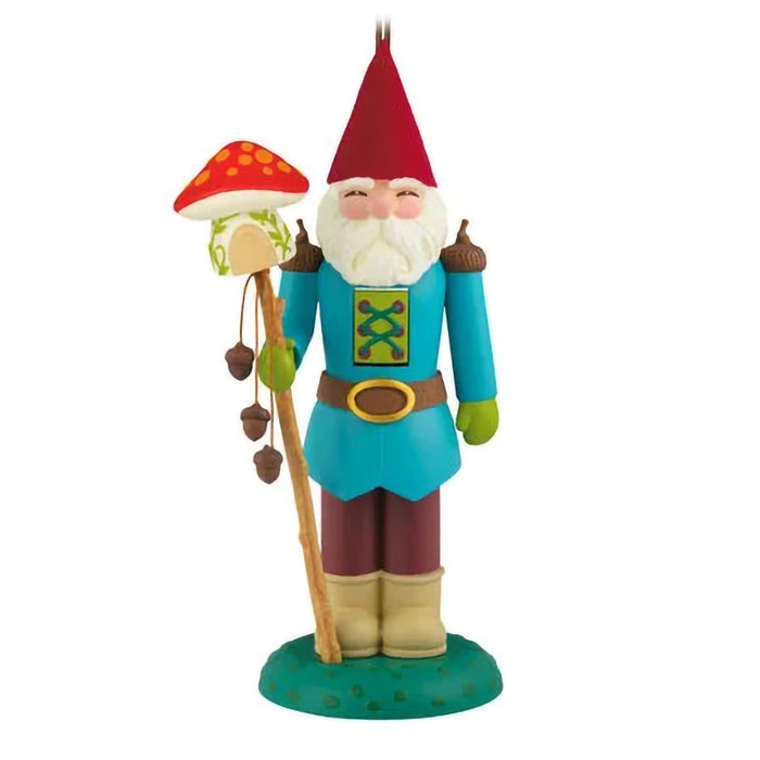 Colorful gnome ornament figurine with a red hat and mushroom on a white background