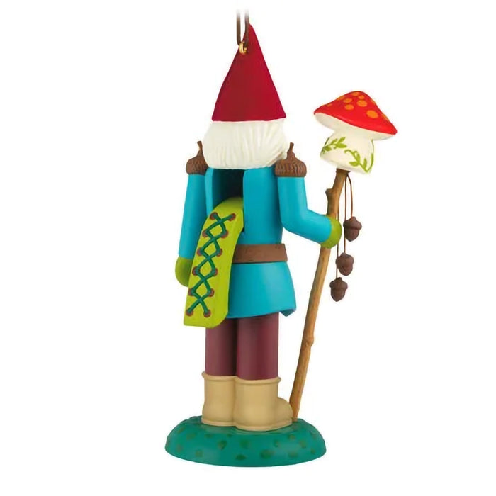 Colorful gnome figurine with a red hat and mushroom on a white background