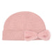 Cheveux Corp blush pink ribbed knit beanie with a rounded crown, wide folded cuff, and large matching faux fur bow on the right side of the cuff, shown against a white background.