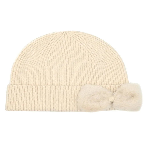 Cheveux Corp blush pink ribbed knit beanie with a rounded crown, wide folded cuff, and large matching faux fur bow on the right side of the cuff, shown against a white background.