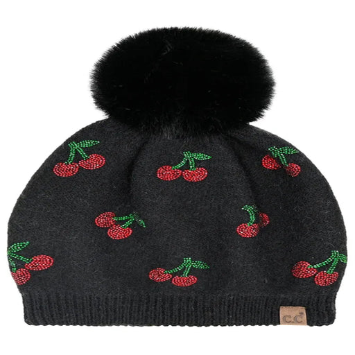 Black Cheveux Corp beanie with red rhinestone cherries, green stems, and a fluffy ivory pom-pom.