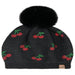 Black Cheveux Corp beanie with red rhinestone cherries, green stems, and a fluffy ivory pom-pom.