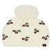 Ivory Cheveux Corp beanie with red rhinestone cherries, green stems, and a fluffy ivory pom-pom.