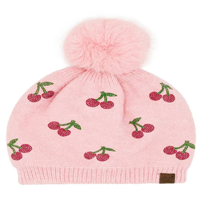 Pink Cheveux Corp beanie with red rhinestone cherries, green stems, and a fluffy ivory pom-pom.