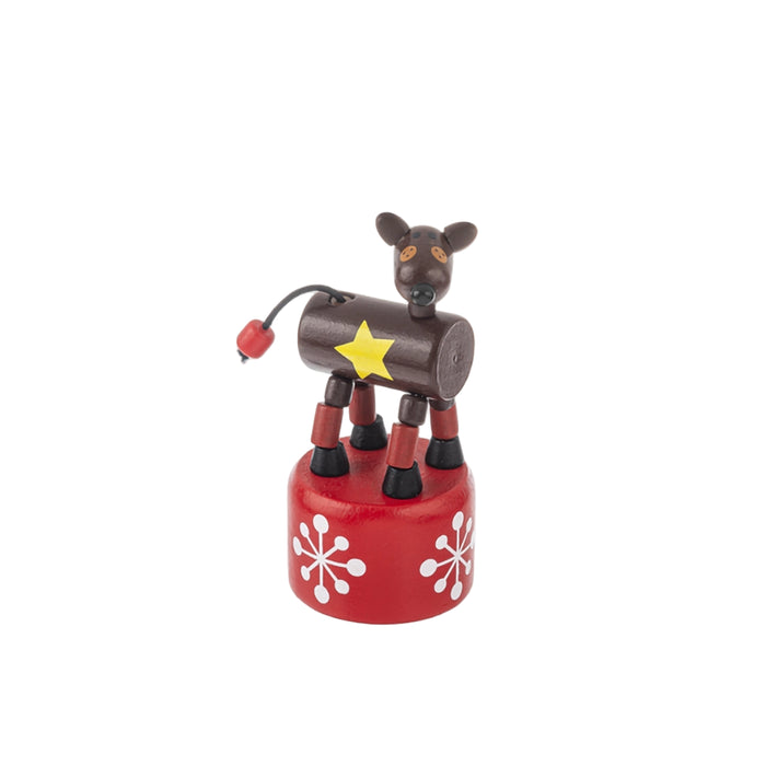 Toy figure of a reindeer on a red base with white snowflake patterns on a white background
