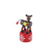 Toy figure of a reindeer on a red base with white snowflake patterns on a white background