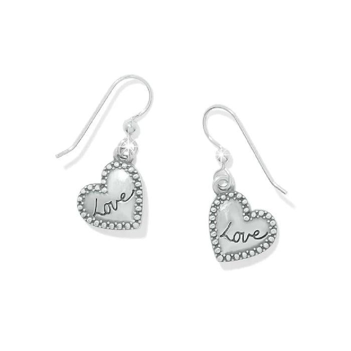 Silver heart-shaped earrings with a shiny surface, perfect for adding a touch of romance to any outfit.