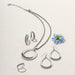 A pair of braided silver hoop earrings, reflecting light beautifully.