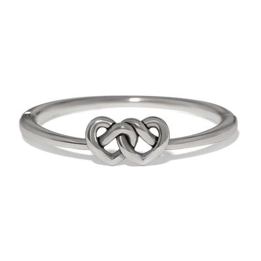 Polished silver Interlok linked hearts hinged bangle featuring intertwined heart motifs with a sleek, elegant design.