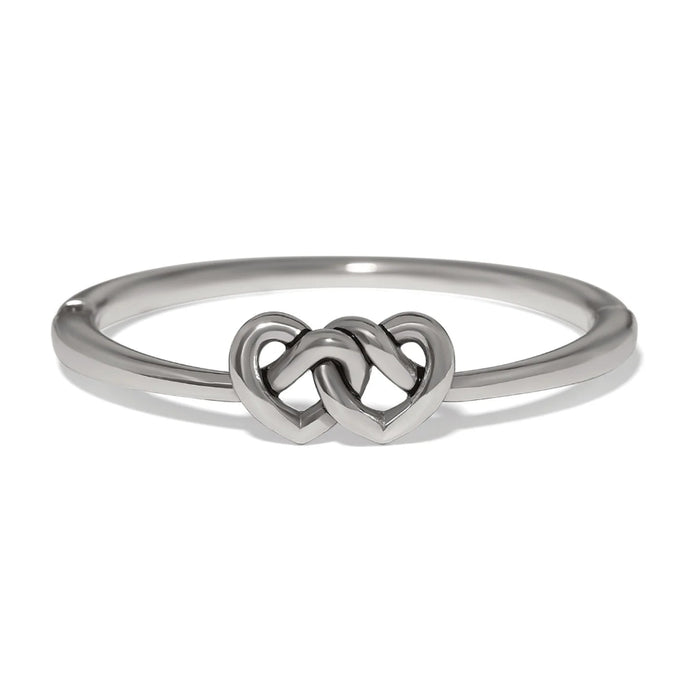 Polished silver Interlok linked hearts hinged bangle featuring intertwined heart motifs with a sleek, elegant design.