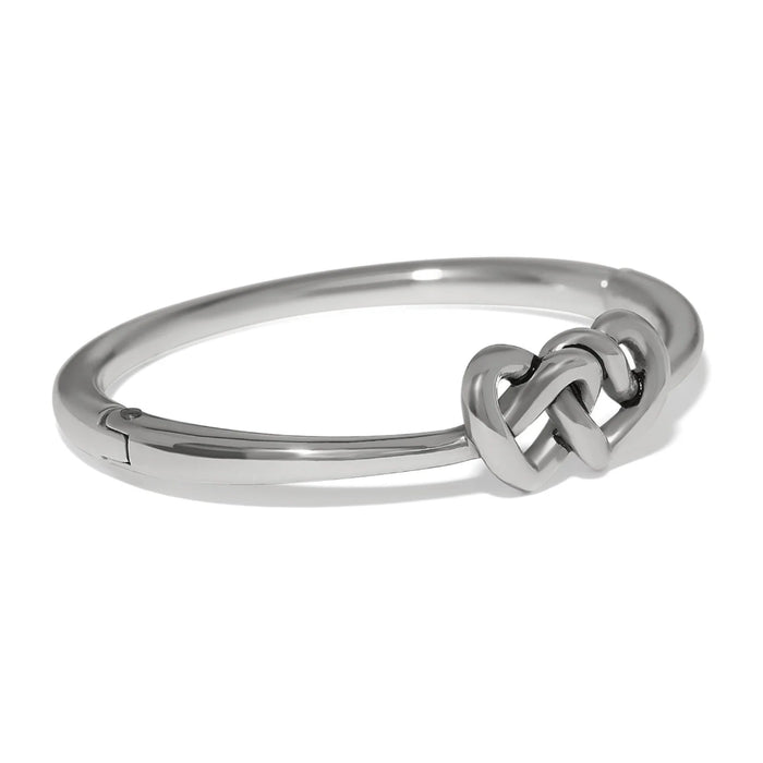 Polished silver Interlok linked hearts hinged bangle featuring intertwined heart motifs with a sleek, elegant design.
