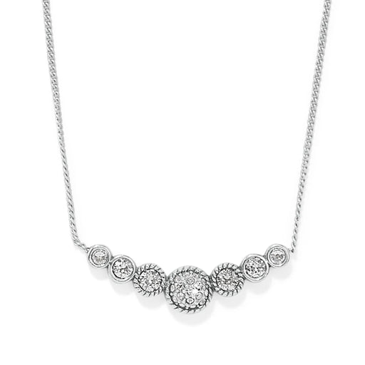 This elegant piece features a slightly curved bar with a petite circular dome at the heart of three stones on either side. A truly precious little treasure, that suspends from a fine delicate chain.