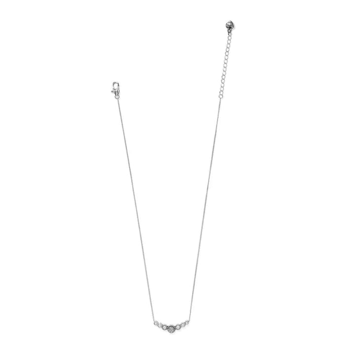 This elegant piece features a slightly curved bar with a petite circular dome at the heart of three stones on either side. A truly precious little treasure, that suspends from a fine delicate chain.