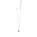 A compact square pendant on a gold and silver chain, representing a refined accessory choice.