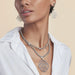 Wear it as a statement piece or pair it with coordinating jewelry for a polished look.