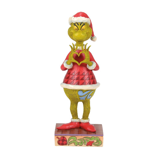 Front view of Jim Shore Grinch with Heart Hands figurine wearing a red Santa outfit.
