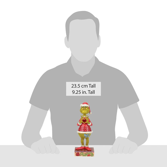 Size comparison of 9.25-inch Grinch figurine shown beside person for scale.