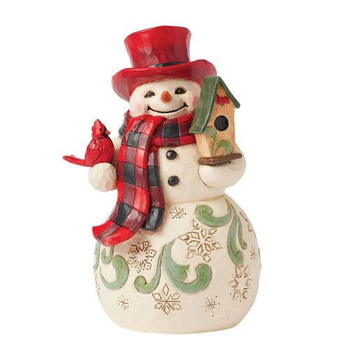 Front view of Jim Shore Highland Glen Snowman Hat Figurine with red hat and cardinal.