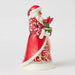 Side view of Santa figurine showing carved folk-art details and hand-painted patterns.