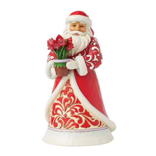 Front view of Jim Shore Santa with Blooming Amaryllis figurine in red coat holding flowers.